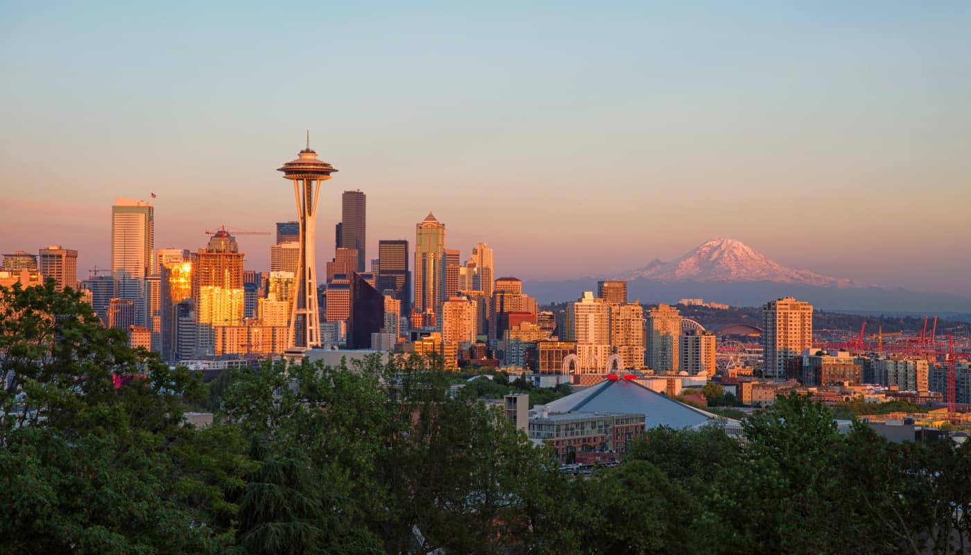 A city skyline with a mountain in the background.