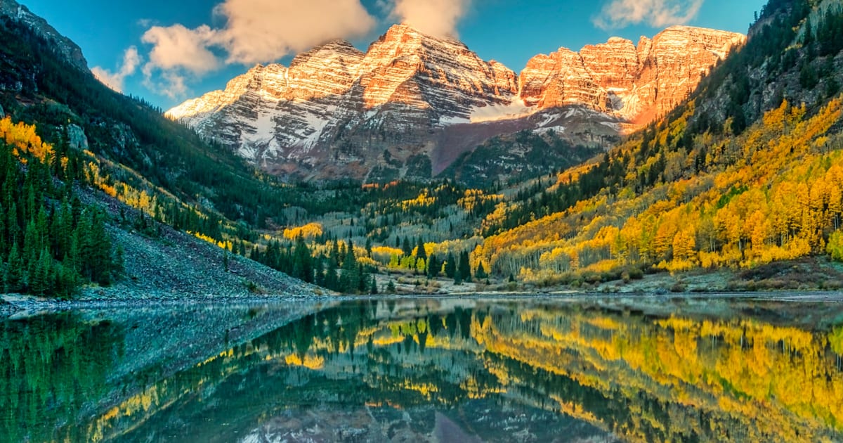 A mountain range is reflected in a lake.
