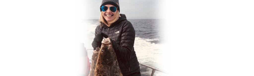 Working Tourist: Travel nurse posing for photo with fish she caught in Alaska