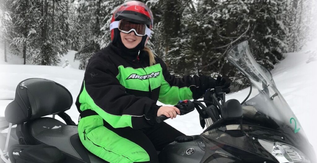 Working Tourist: photo of healthcare professional, Haley W, chasing the northern lights on her snowmobile