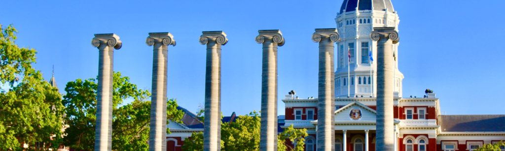 Outside image of five pillars overlooking a courthouse in Missouri