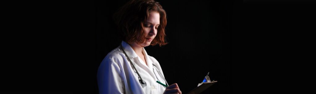 Image: Nurse writing in chart