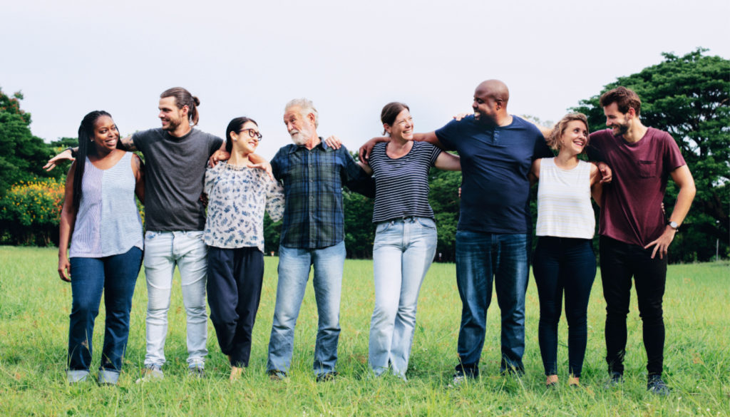 Photo of eight people standing arm in arm, representing all ethnicities and genders affected by heart disease