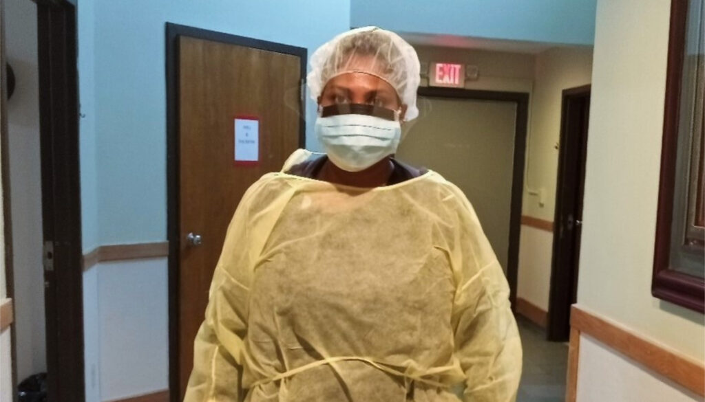 Image of a nurse in full scrub with mask ready to combat ongoing COVID-19 pandemic
