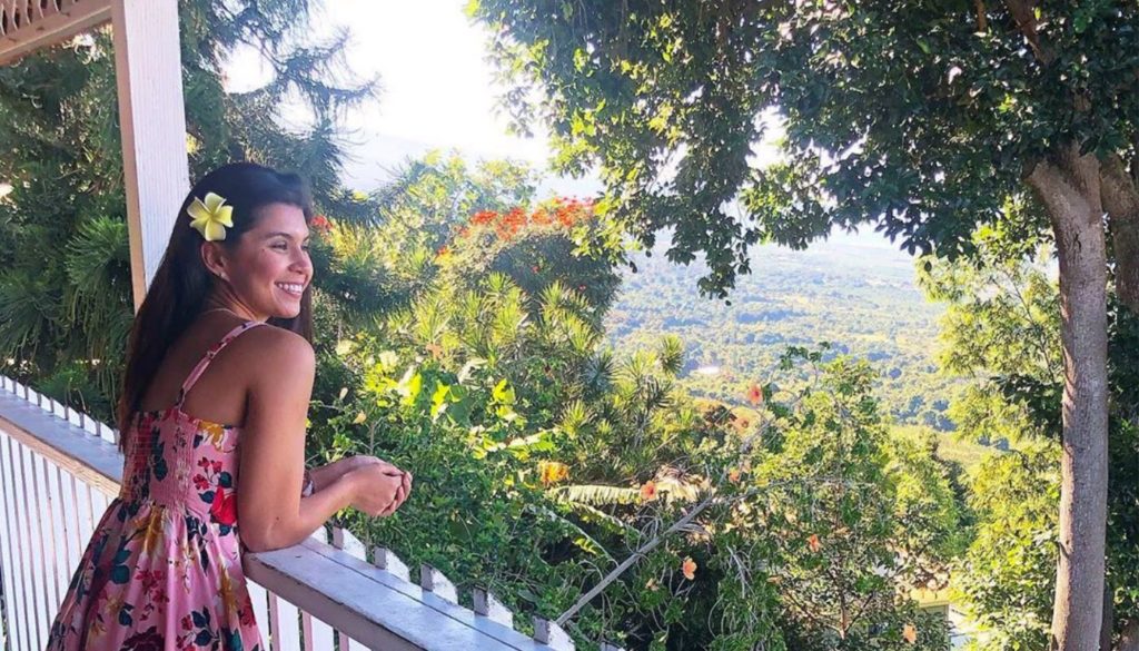 Photo of travel occupational therapist Jackie, looking at nature over a porch