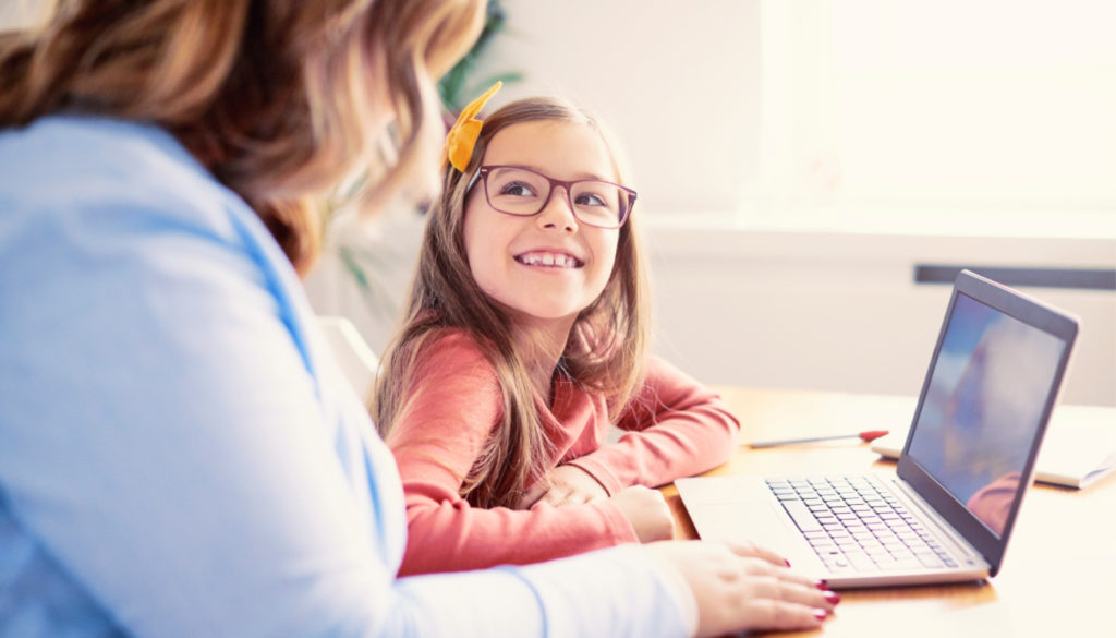 Image of teacher and young student learning during one on one session using a laptop
