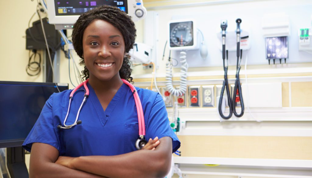 photo of woman nurse smiling towards camera while in the operating room