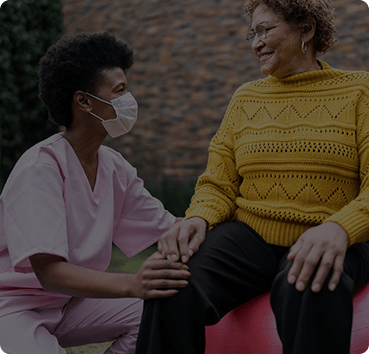 image of a nurse checking the knee of a woman patient