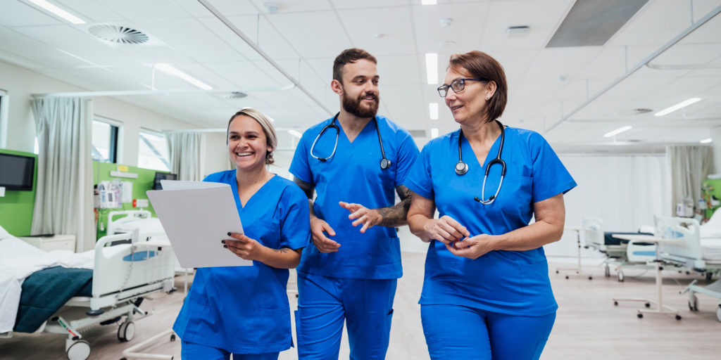 Image of three nurses talking facing the camera