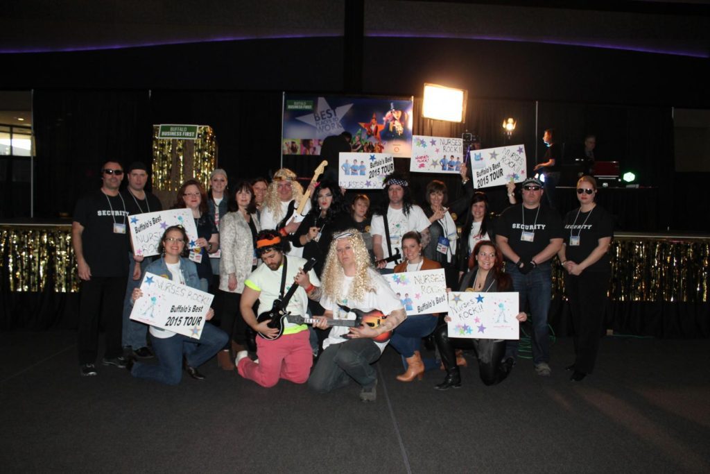 group photo of the entire staff of buffalo healthcare workers dressed as a rock and roll band