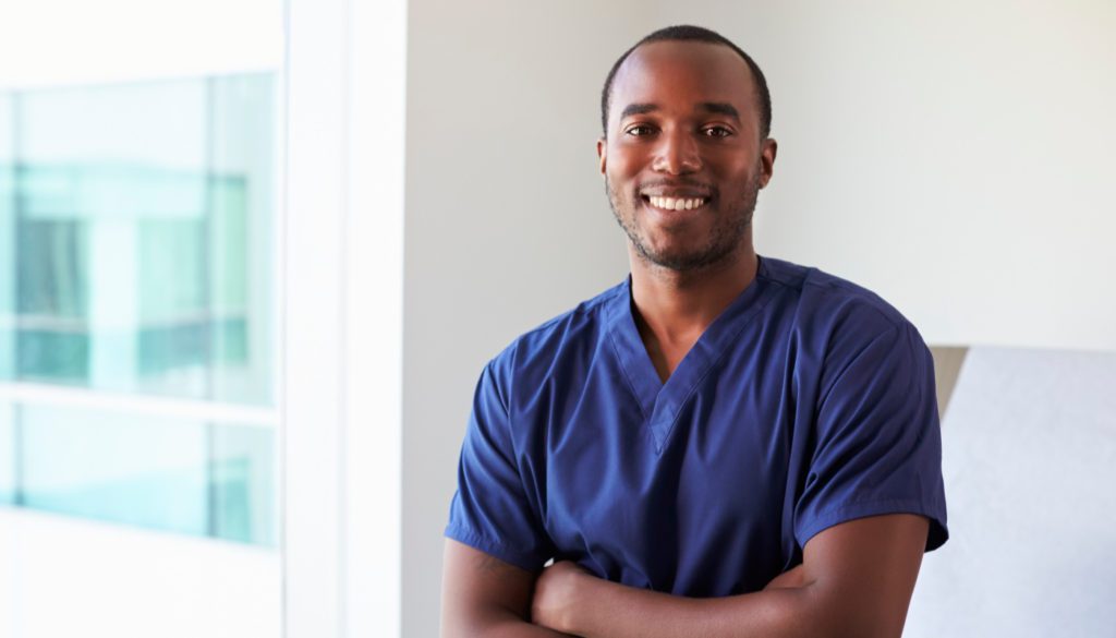 Photo of a male nurse smiling toward the camera