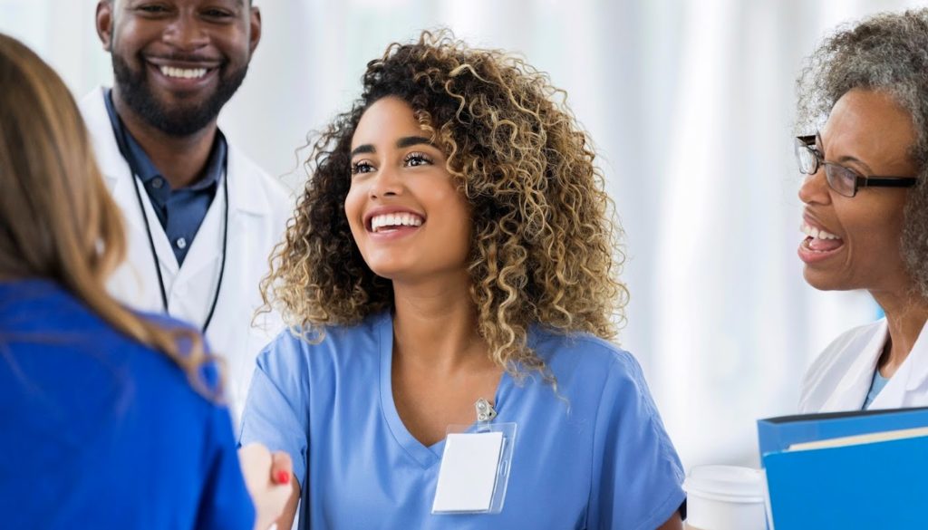 image: medical professionals smiling as they meet someone