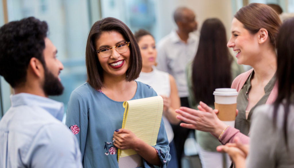 Image: Group of professionals chatting and smiling