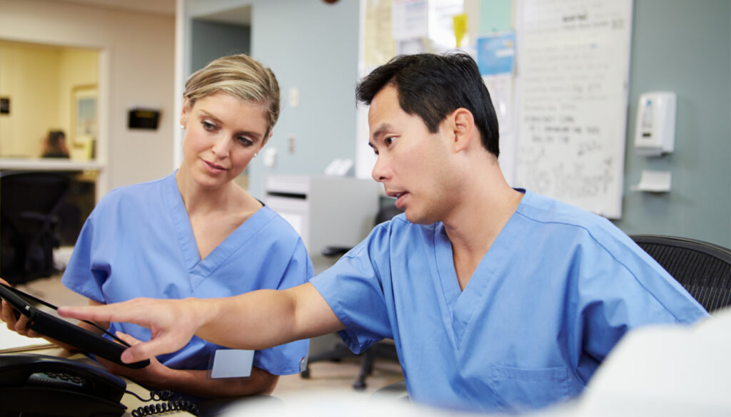 Image: Two nurses considering information on smart tablet. Supplemental Health Care prepares for potential hurricane.