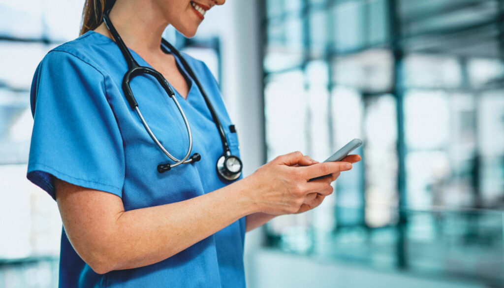 Banner: Woman nurse using smart phone. Download the SHC We Connect healthcare jobs app from the Google PLay Store or from the Apple Store.
