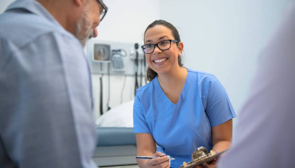 A nurse is talking to a patient in a hospital.