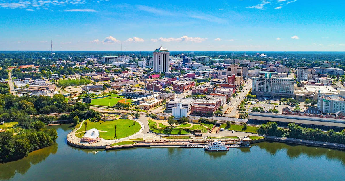 An aerial view of a city with a river in the background.