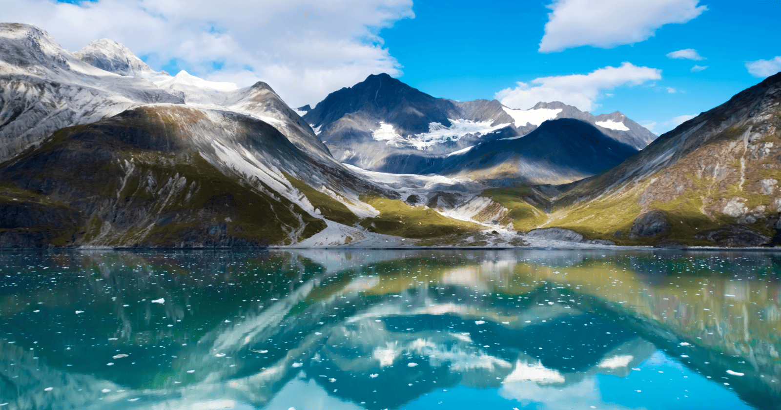 A lake with mountains reflected in it.