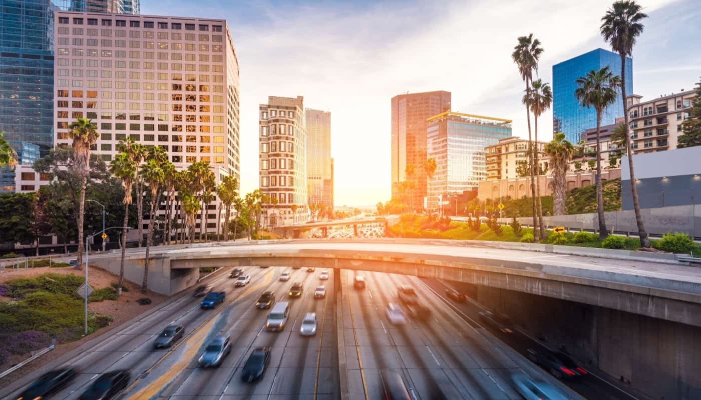 Cars driving on a freeway at sunset in los angeles, california.