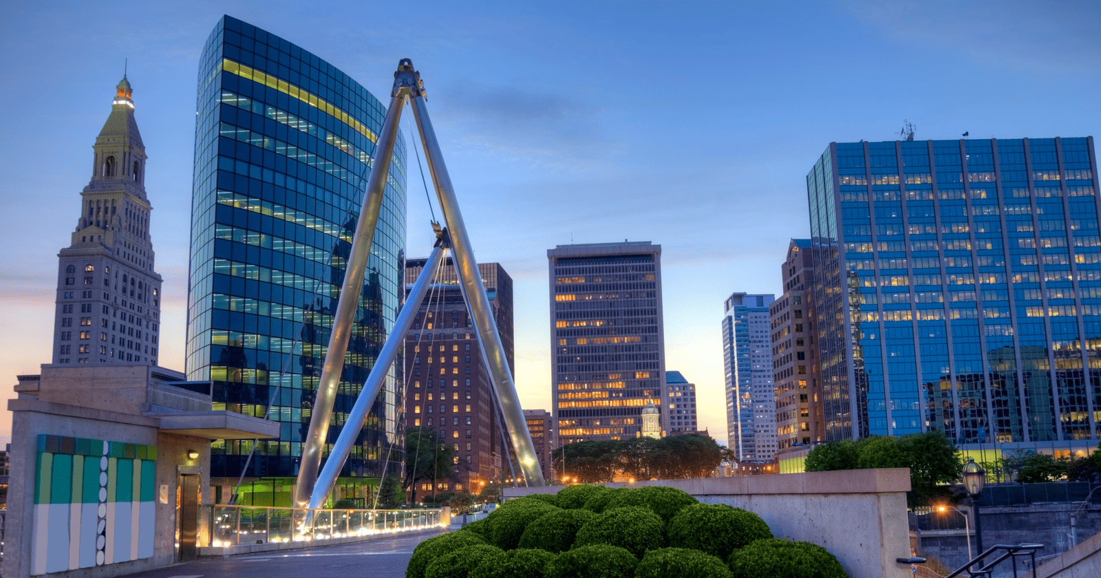 A city at dusk with tall buildings in the background.