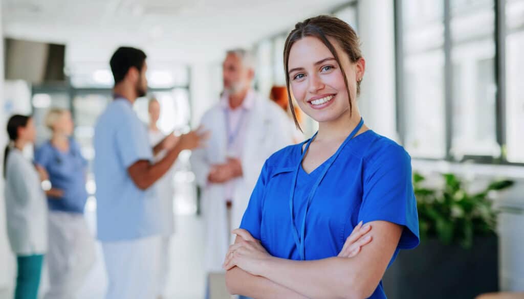 A nurse standing in front of a group of people.
